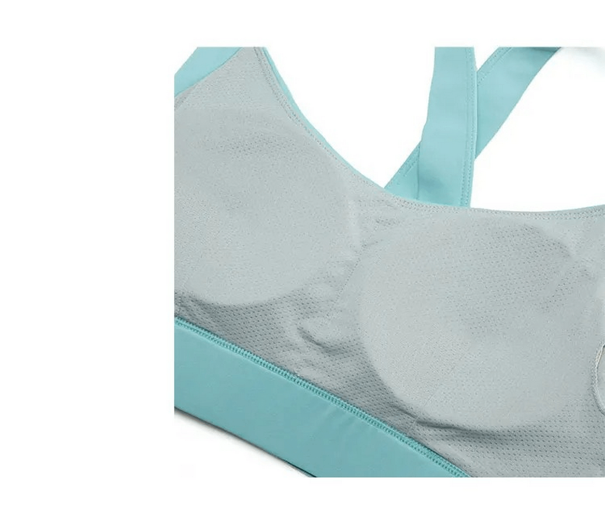 Close-up of a stylish, breathable sports bra with a light blue tone, showcasing mesh fabric and comfortable straps for women's activewear.